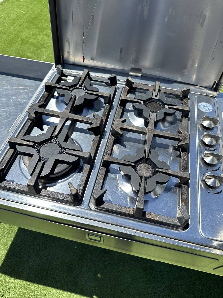 3D-printed burner stove protectors fitted to a caravan cooktop